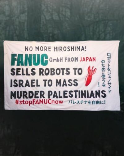 REPORT: Berlin – Banner drop on International Action Day (12.02.2026) against FANUC genocide robotics